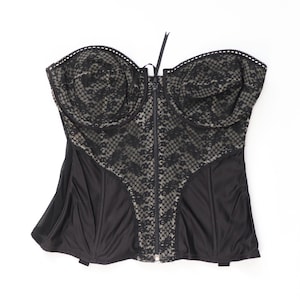 May include: A black strapless corset with a lace overlay and a front zipper closure.