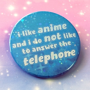 May include: A blue button with a glittery finish and the text "i like anime and i do not like to answer the telephone" in white.