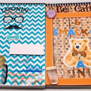 May include: A notebook with a spiral binding, featuring two pages. The left page has a blue and white zig-zag pattern with text and illustrations. The right page has a bear holding a donut and the words 'Be Calm & Smack on a Donut'.