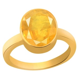 Könnte beinhalten: Ein goldener Ring mit einem großen, ovalen, gelben Edelstein.