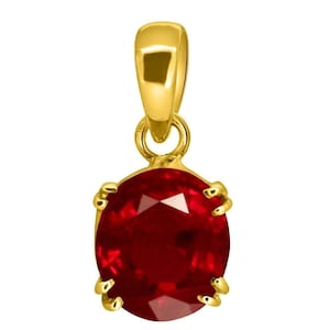 May include: A gold pendant featuring a red oval gemstone. The pendant has a simple design with a bail at the top and a bezel setting for the gemstone.