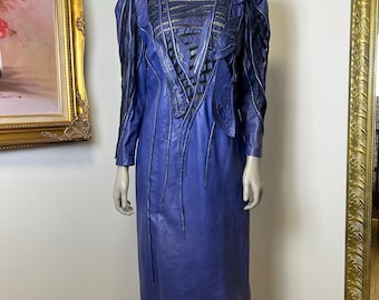 May include: A blue leather dress with a lace overlay and a unique design. The dress has a fitted bodice and a flowing skirt.