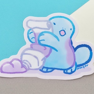 May include: A blue and purple cartoon platypus sticker with a white and purple tube of paint. The platypus is holding the paint tube and has a surprised expression on its face. The sticker has the word "Porter" written on it.