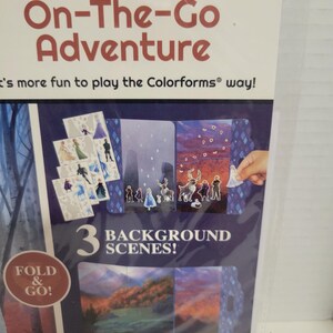 May include: A colorful cardboard box with a blue background and the words "Jumbo On-The-Go Adventure" in red. The box features a picture of a Frozen character and the text "3 Background Scenes!" in white. The box is designed for children ages 3 and up.