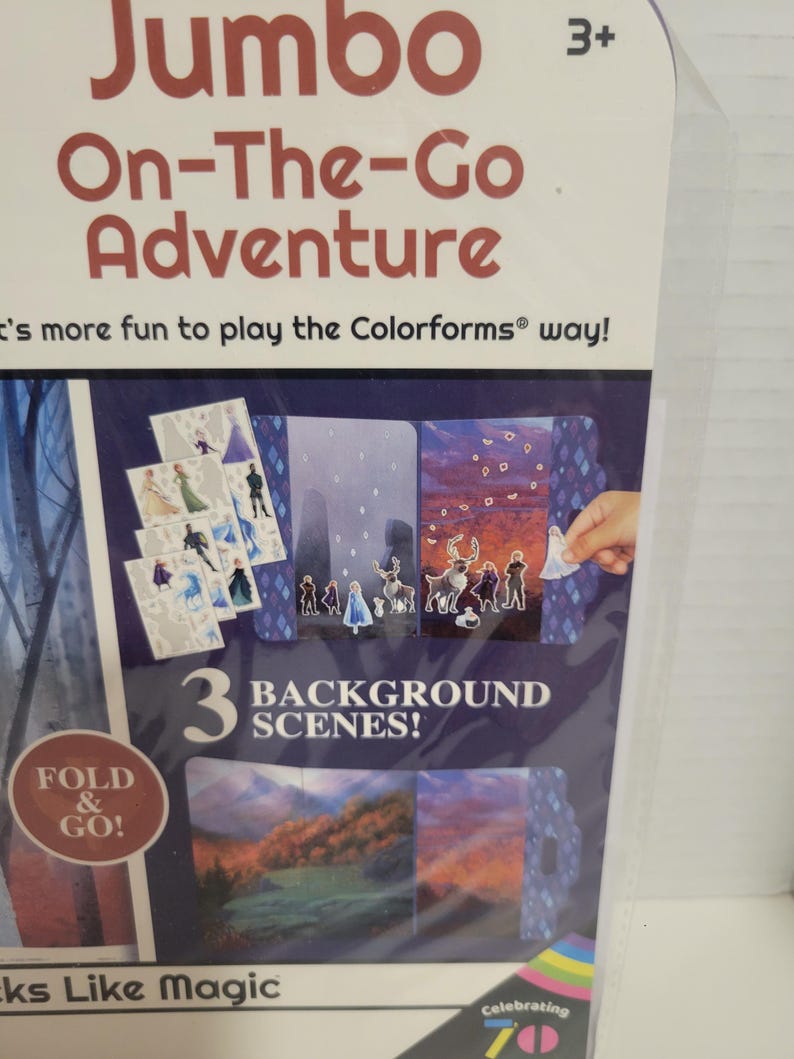 May include: A colorful cardboard box with a blue background and the words "Jumbo On-The-Go Adventure" in red. The box features a picture of a Frozen character and the text "3 Background Scenes!" in white. The box is designed for children ages 3 and up.
