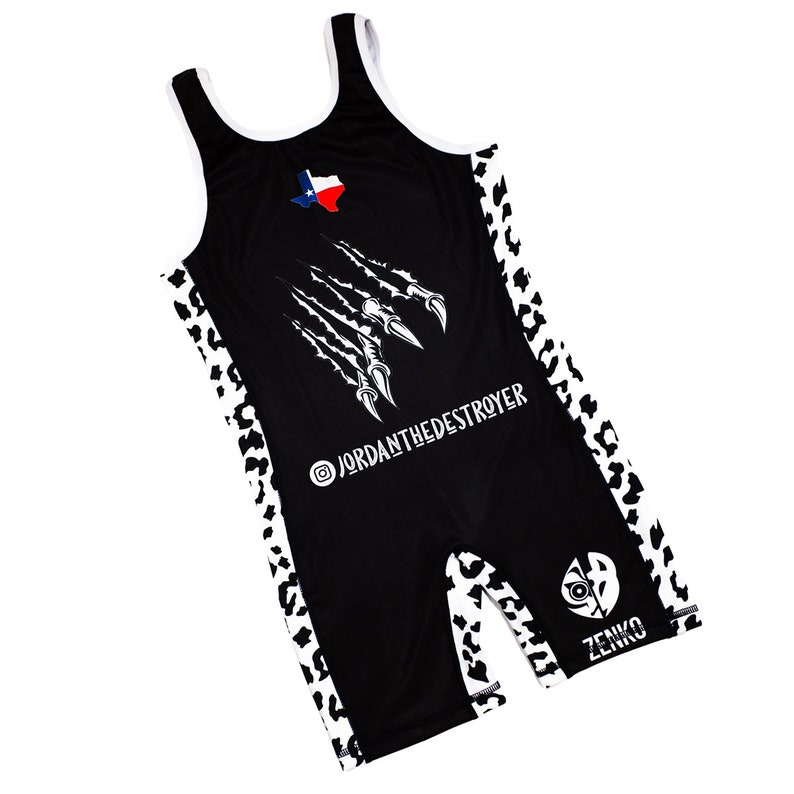 May include: Black wrestling singlet with white leopard print trim. The singlet features a white claw mark graphic, a Texas flag, and the text "@jordanthedeestroyer" and "ZENKO".
