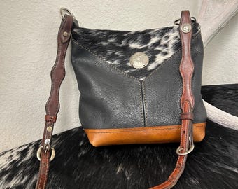 One of a kind , hair on hide and leather shoulder bag, with vintage concho and scalloped headstall horse tack for strap