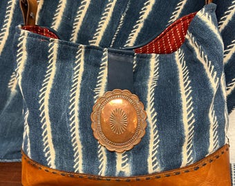 Vintage copper concho on hand made Mali textile witrh horse tack strap