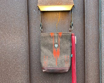 One of a  kind ,navajo textile ,leather shoulder bag with 14” red fringe with turquoise and silver tips