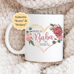 May include: White ceramic mug with a gold heart design and floral accents. The text "Najbolja Baba - Na Svijetu" is printed on the mug.