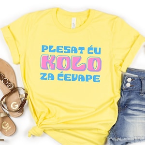May include: Yellow t-shirt with the text "PLESAT ĆU KOLO ZA ĆEVAPE" in blue and pink letters.