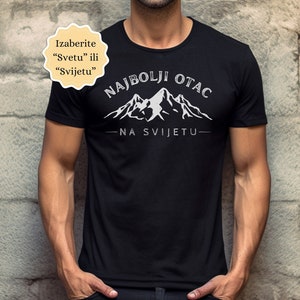 May include: Black t-shirt with white text that reads "Najbolji Otac Na Svijetu" which translates to "Best Dad in the World". The text is surrounded by a mountain range graphic.