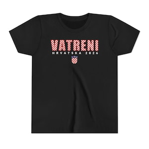 May include: Black t-shirt with the word "VATRENI" in a red and white checkered pattern. Below the word is "HRVATSKA 2026" in white text, and a Croatian coat of arms.
