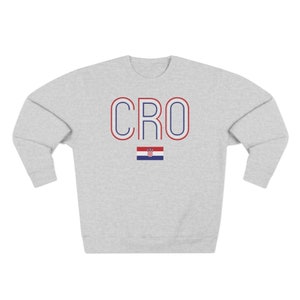 May include: A grey sweatshirt with the word "CRO" in blue and red letters with a white outline. The Croatian flag is below the letters.