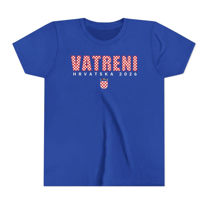 May include: Royal blue t-shirt with the word "VATRENI" in a red and white checkered pattern. Below the word is "HRVATSKA 2026" in white text, and a Croatian coat of arms. The shirt is a youth size.