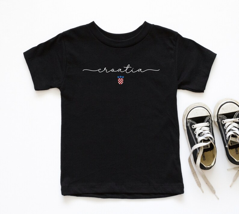 May include: Black t-shirt with the word "croatia" written in white script and a small Croatian flag graphic below.