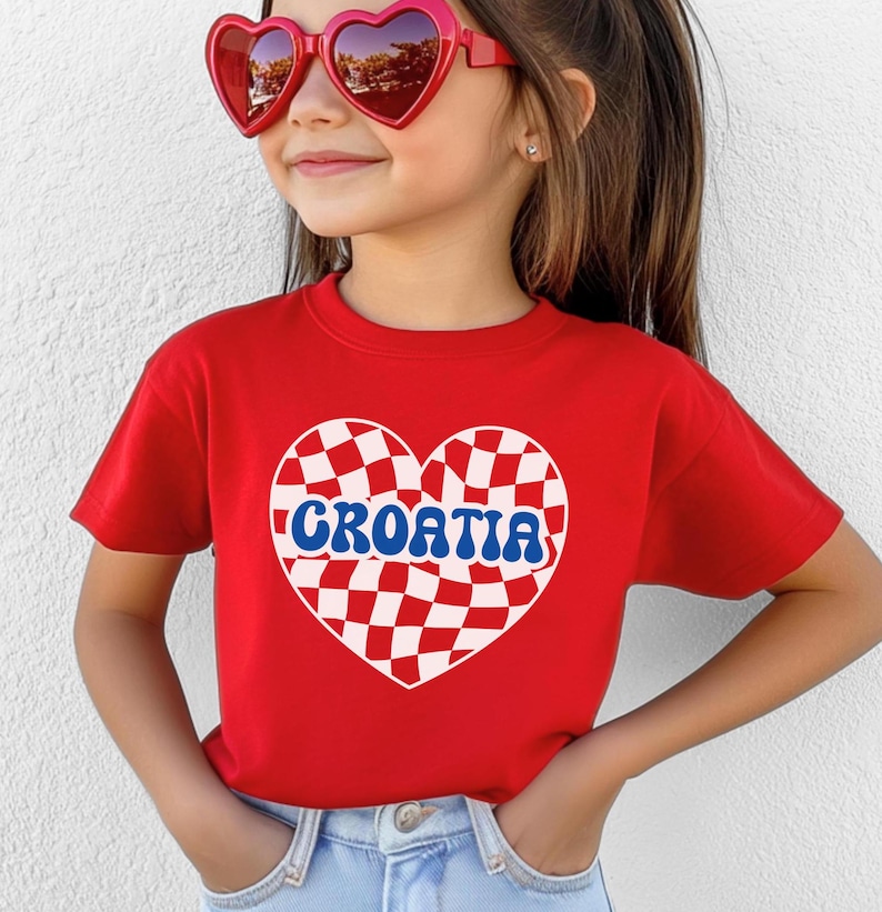 May include: Red t-shirt with a white and red checkered heart design and the word "CROATIA" in blue letters.