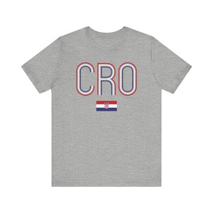 May include: A gray t-shirt with the word "CRO" in red, white, and blue stripes. The Croatian flag is below the word.