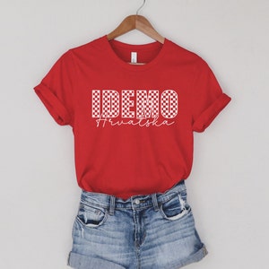 May include: Red t-shirt with a white checkered design that says "IDEMO Hrvatska" in white.