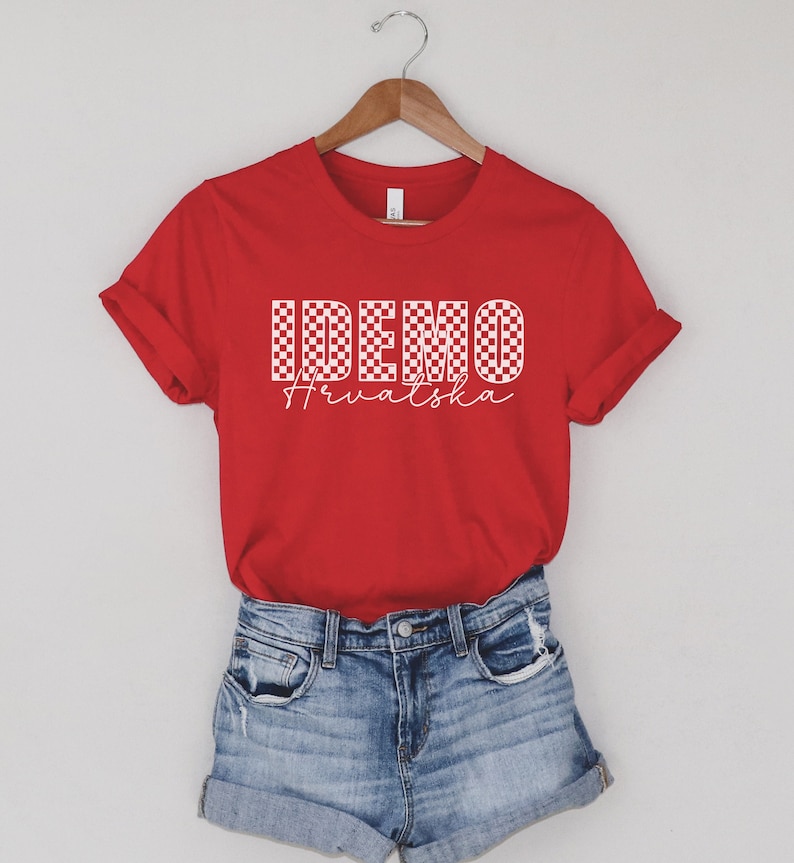 May include: Red t-shirt with a white checkered design that says "IDEMO Hrvatska" in white.