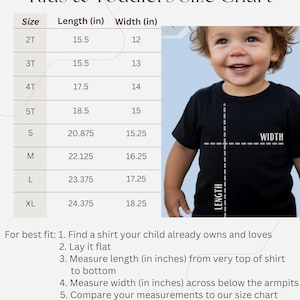 May include: Kids and toddlers size chart with a table showing length and width measurements in inches for sizes 2T, 3T, 4T, 5T, S, M, L, and XL. A child wearing a black t-shirt is shown with lines indicating length and width measurements.