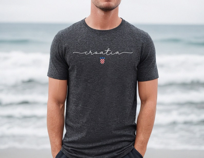 May include: A dark gray t-shirt with the word "croatia" written in white script across the chest. The Croatian coat of arms is centered below the word.