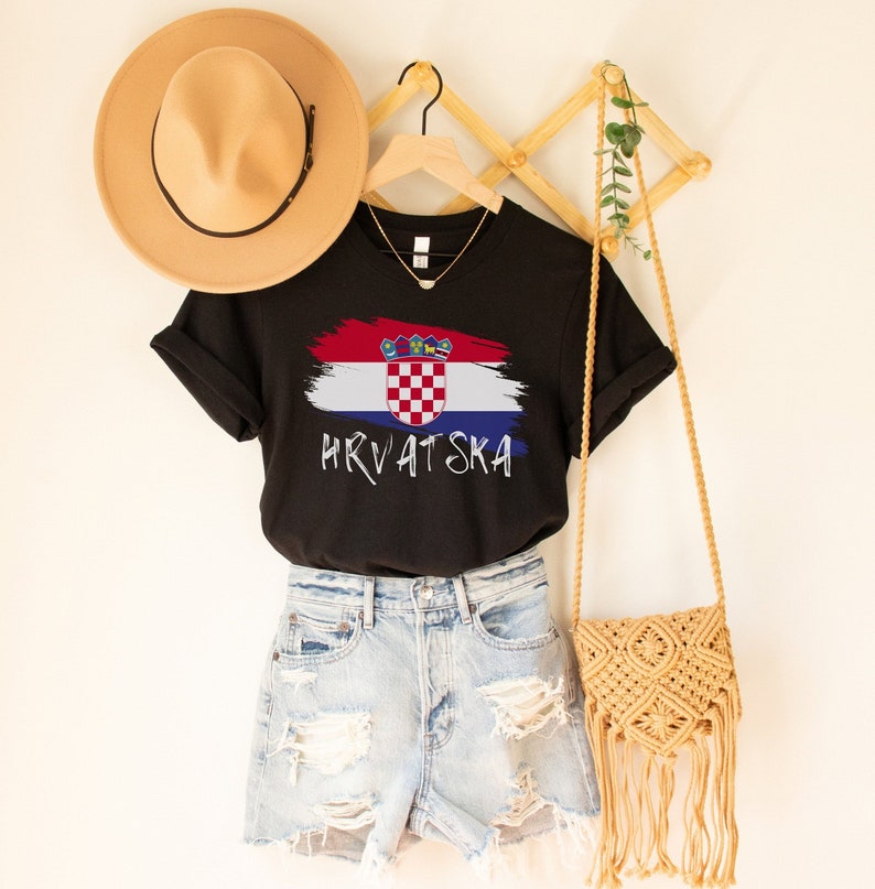 May include: Black t-shirt featuring a white paint-splattered Croatian flag and the text "HRVATSKA" in white.