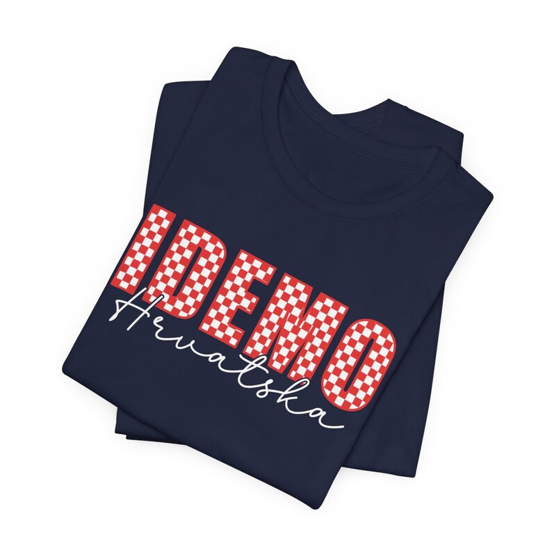 May include: A navy blue t-shirt with a red and white checkered design that says "IDEMO Hrvatska".