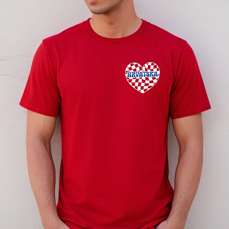 Pu&ograve; includere: Maglietta rossa con un cuore a scacchi bianco e blu con la parola "HRVATSKA" in lettere blu.