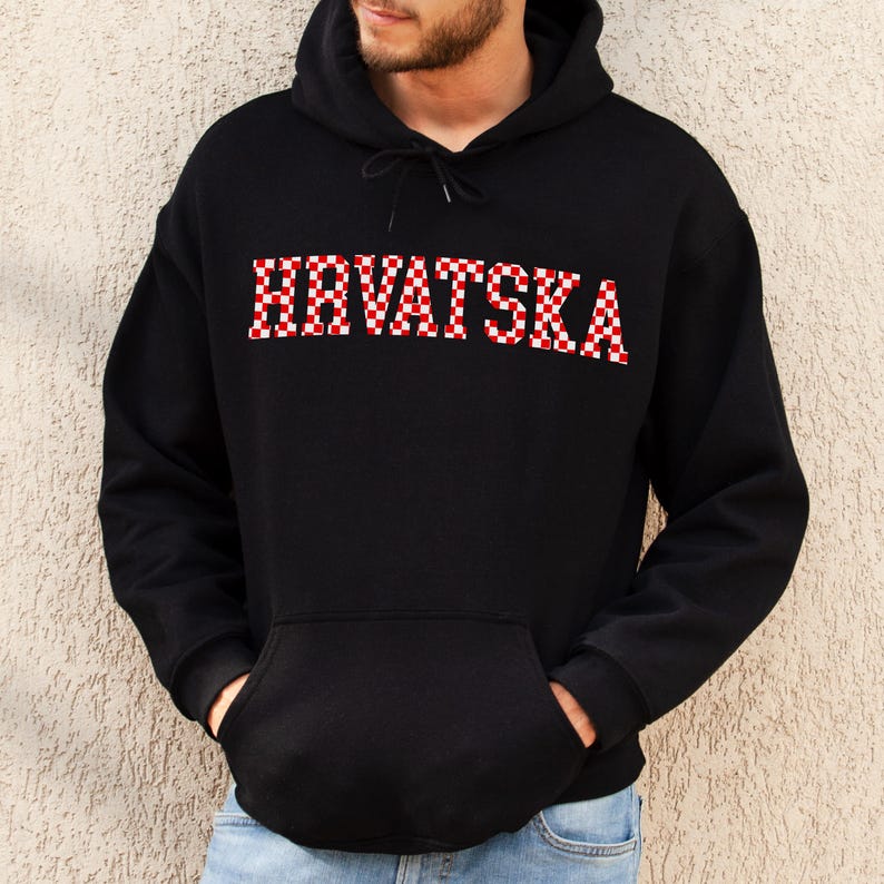 May include: Black hooded sweatshirt with the word "HRVATSKA" in red and white checkered letters across the chest. The sweatshirt has a front pocket and a drawstring hood.
