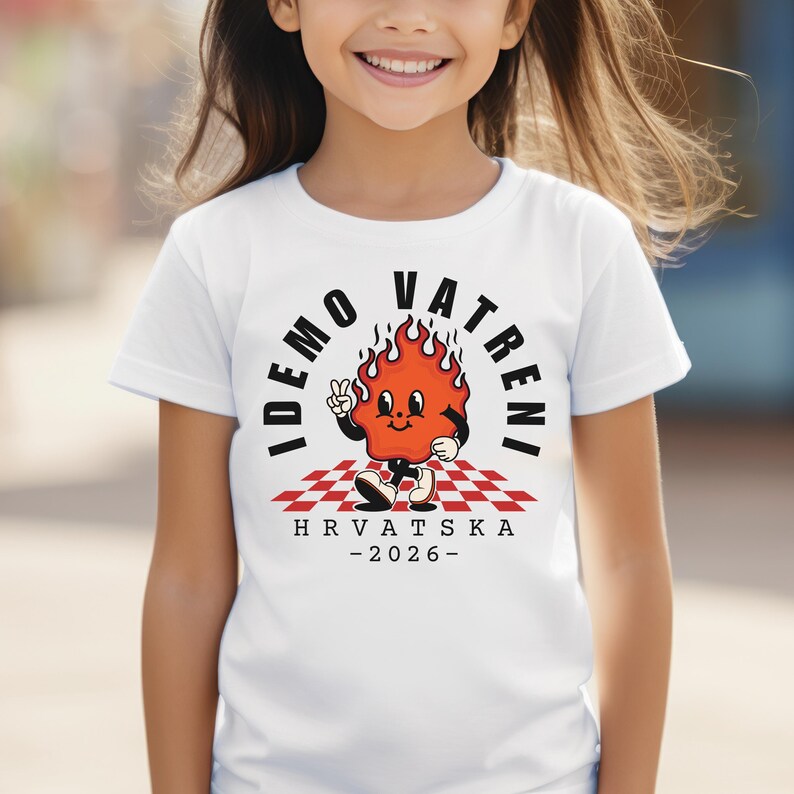 May include: White t-shirt featuring a cartoon flame character with the text "IDEMO VATRENI" in a semi-circle above the flame. The flame is on a red and white checkered pattern with the text "HRVATSKA - 2026-" below.