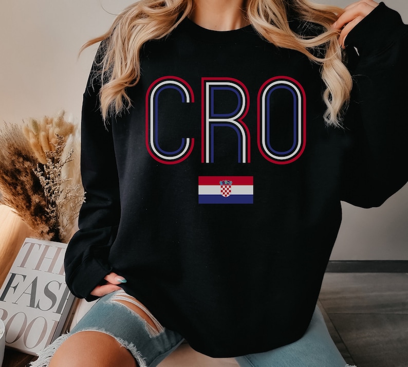 May include: Black sweatshirt with the word "CRO" in white and red outlined letters. A Croatian flag is below the word.
