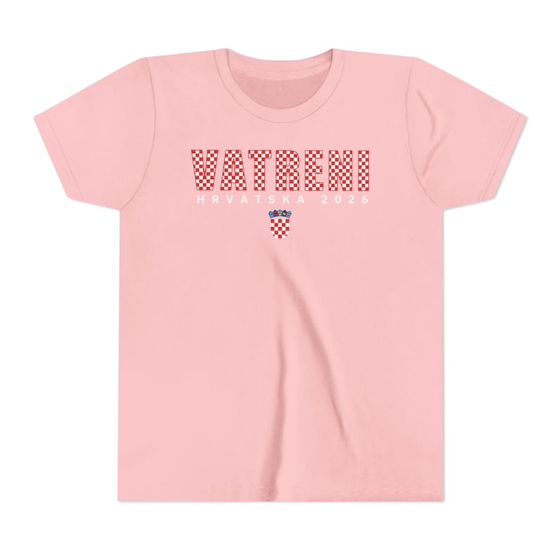 May include: A light pink t-shirt with the word "VATRENI" in a red and white checkered pattern across the chest. Below the word is the text "HRVATSKA 2026" and a Croatian coat of arms.