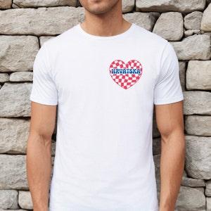 Pu&ograve; includere: Maglietta bianca con un cuore a scacchi rosso e bianco con la parola "HRVATSKA" in lettere blu.