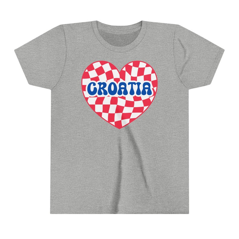 May include: A gray t-shirt with a red and white checkered heart design. The heart has the word "CROATIA" written in blue letters.