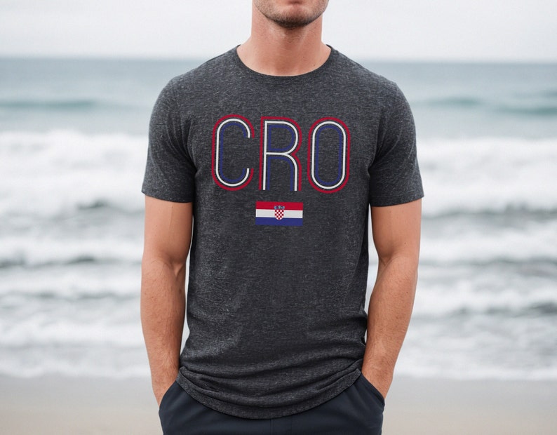 May include: A dark gray t-shirt with the word "CRO" in white outlined in red and blue. A small Croatian flag is below the word.