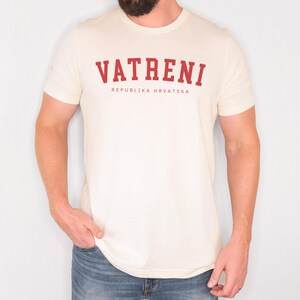 May include: A white t-shirt with a red print that says "VATRENI REPUBLIKA HRVATSKA".