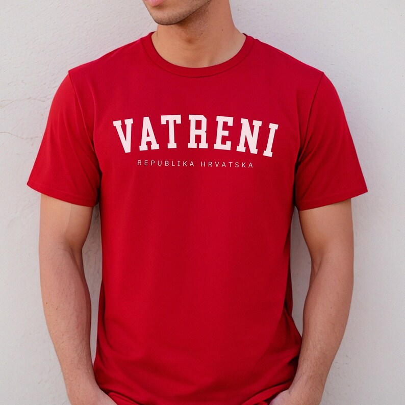 May include: Red t-shirt with white text that reads "VATRENI REPUBLIKA HRVATSKA".