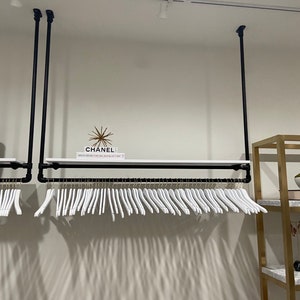 Ceiling mounted clothing rack with shelf