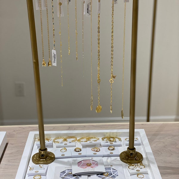 Gold and white necklace display bar