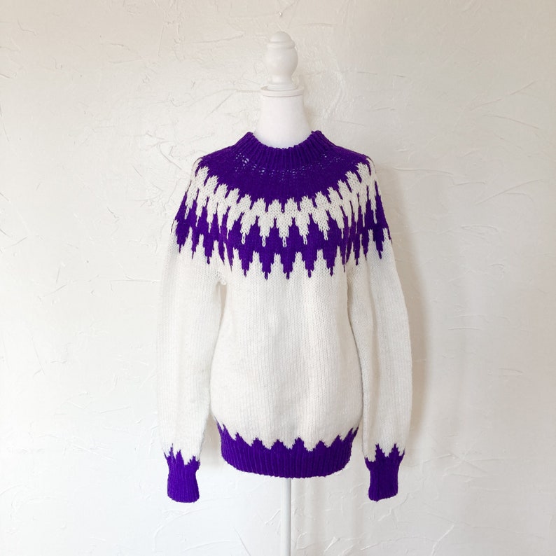 Bright white sweater with fair isle purple knit design, mock neck, pullover style