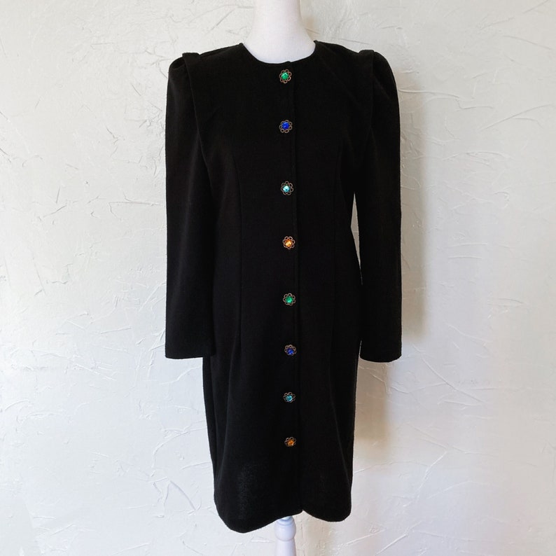 Black knit dress with paneled shoulder, multicolored glass gem rainbow buttons down the front.