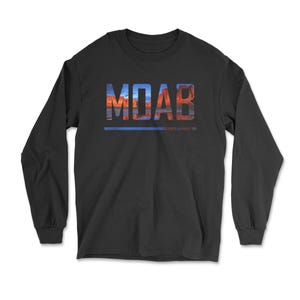 May include: Black long-sleeve shirt with the word "MOAB" in large, colorful letters across the chest. The letters are filled with a landscape design featuring red rock formations and a blue sky. A blue line underlines the word.