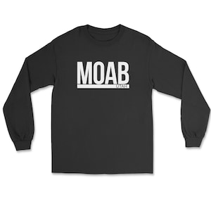 May include: Black long-sleeve shirt with the word "MOAB" in white block letters above the word "UTAH". The shirt is a crew neck style and is made of a soft material.
