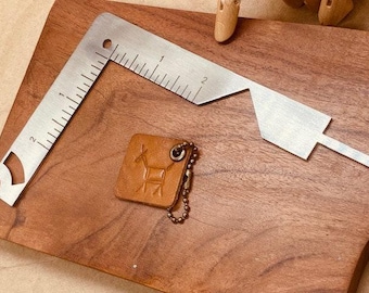 Bookbinding tool in heavy metal gauge (5-in-1).