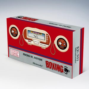 Könnte beinhalten: Eine rote und graue Nintendo Micro Vs. System Boxing Spielkonsolenbox. Die Box zeigt ein Retro-Handheld-Spiel mit einem Bildschirm und Steuerungstasten. Der Text "MICRO VS. SYSTEM" und "BOXING" sind sichtbar.