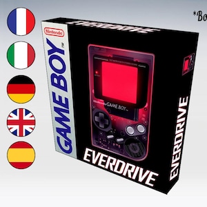 Puede incluir: Una caja negra de Game Boy Everdrive con un Game Boy rojo en la parte delantera. La caja tiene el texto "Game Boy" y "Everdrive".