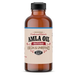 May include: A brown glass bottle with a black cap and a label that reads "Original Creekwood Naturals Amla Oil Natural Virgin & Unrefined Creekwood Quality".