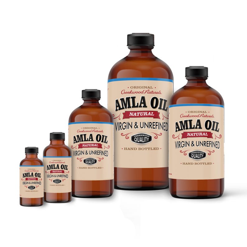 May include: Five amber glass bottles of Amla Oil, labeled "Original Creekwood Naturals Amla Oil Natural Virgin & Unrefined" with a red and white label. The bottles are of various sizes, with the largest bottle in the center.