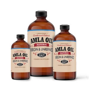 May include: Three amber glass bottles of Amla Oil, labeled "Original Creekwood Naturals Amla Oil Natural Virgin & Unrefined" with a hand-drawn logo and the text "Creekwood Quality" in a black circle. The bottles are of different sizes and are arranged from largest to smallest.